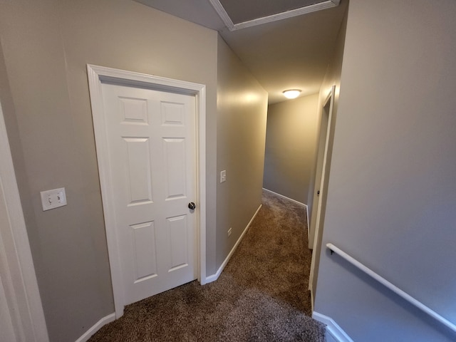 hall featuring dark colored carpet