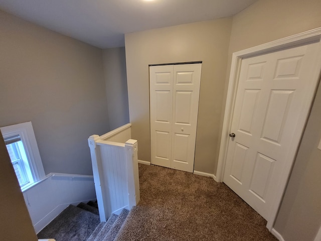 corridor with dark colored carpet