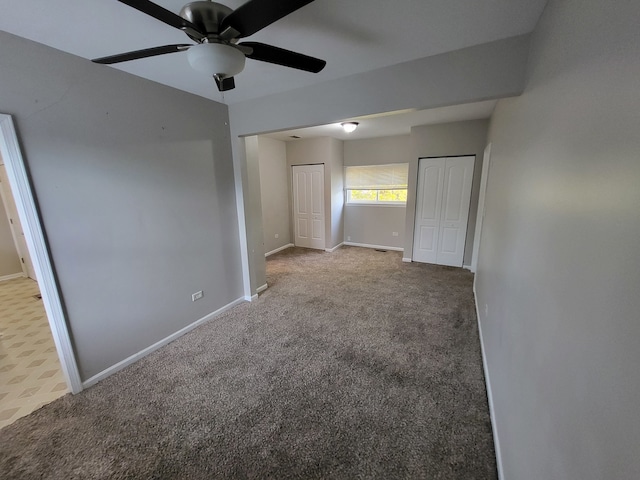 spare room featuring ceiling fan and carpet