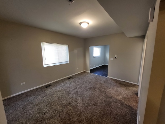 empty room with dark carpet