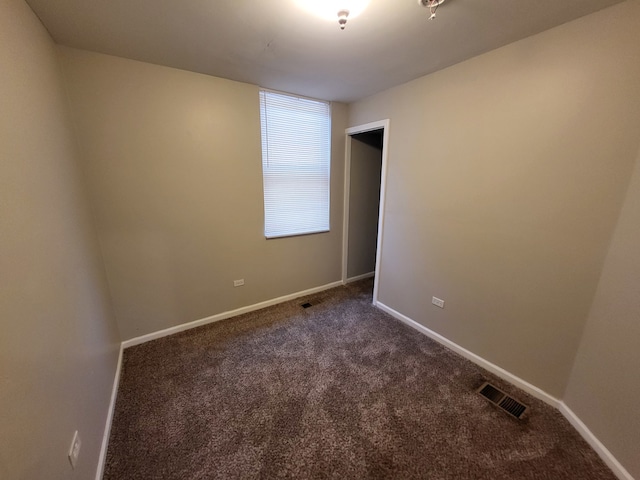 empty room with dark carpet