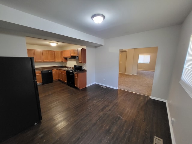 kitchen featuring dark carpet and black appliances