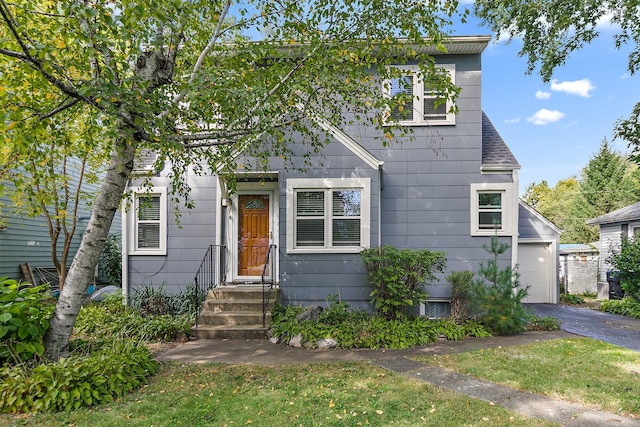 view of front of property with a front lawn and a garage