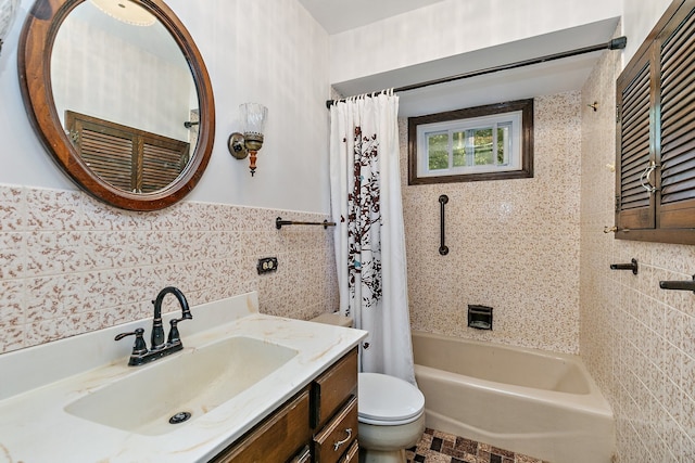 full bathroom featuring vanity, tile walls, and toilet