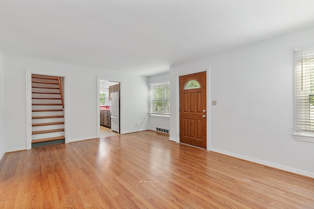 entrance foyer with a healthy amount of sunlight and light hardwood / wood-style floors