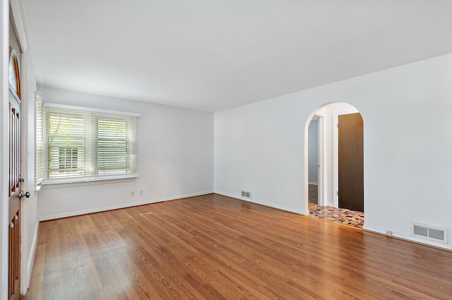 unfurnished room with hardwood / wood-style floors