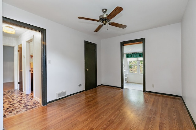 spare room with ceiling fan and hardwood / wood-style floors