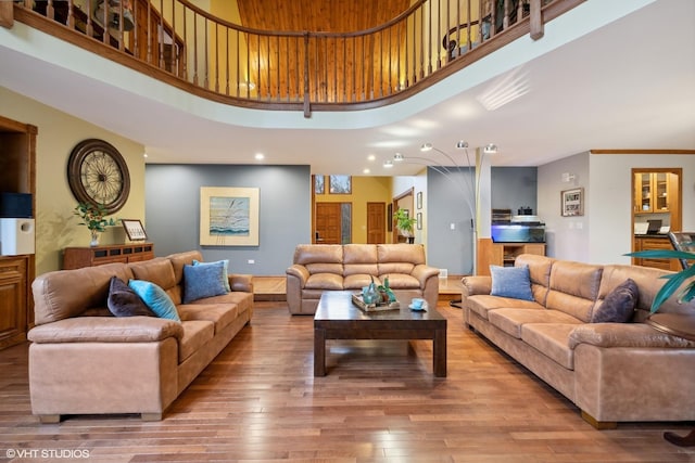 living room featuring hardwood / wood-style floors and a high ceiling