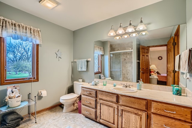 bathroom featuring vanity, an enclosed shower, and toilet