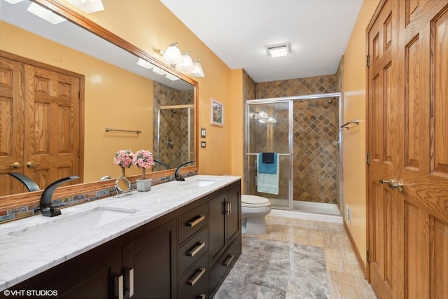 bathroom featuring vanity, toilet, and walk in shower