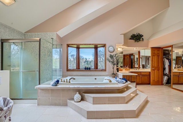 bathroom featuring separate shower and tub, vanity, and high vaulted ceiling