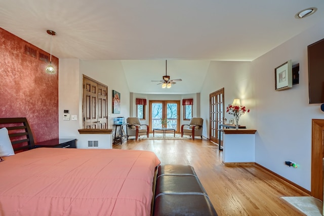 bedroom with ceiling fan, french doors, light hardwood / wood-style floors, and lofted ceiling