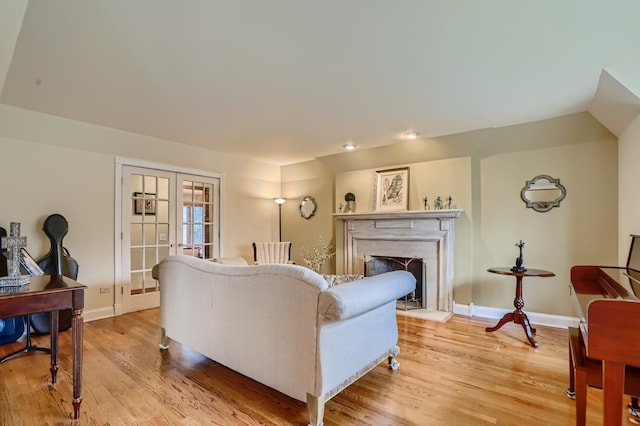 living room with french doors and light wood-type flooring