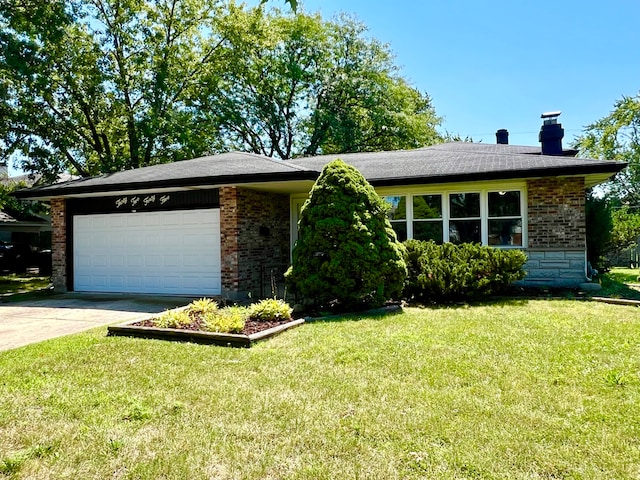 ranch-style house featuring a garage and a front lawn