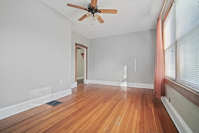 spare room with wood-type flooring, a textured ceiling, and ceiling fan