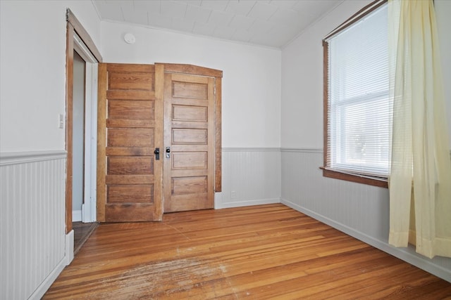 interior space with crown molding and light hardwood / wood-style flooring