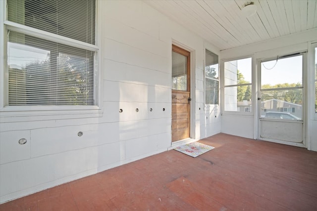 unfurnished sunroom with wood ceiling