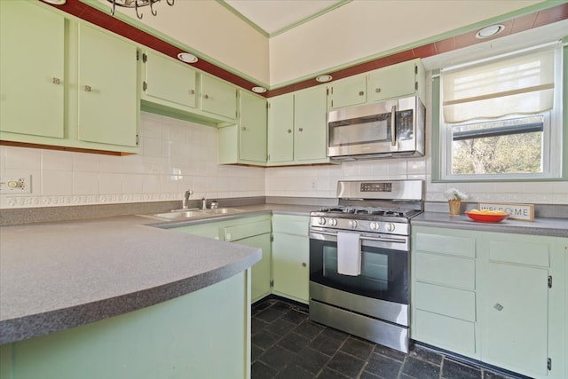 kitchen featuring decorative backsplash, sink, and stainless steel appliances