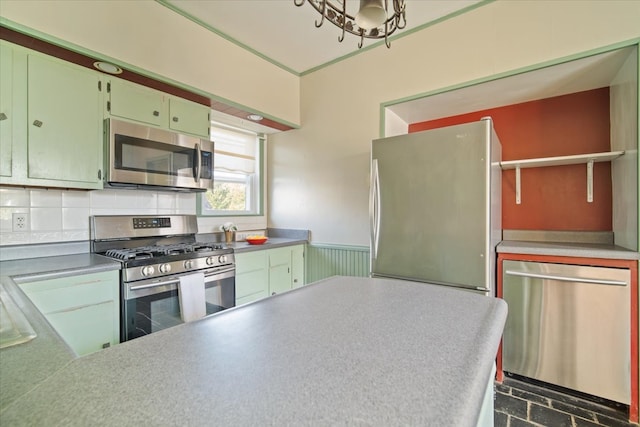 kitchen featuring stainless steel appliances and backsplash