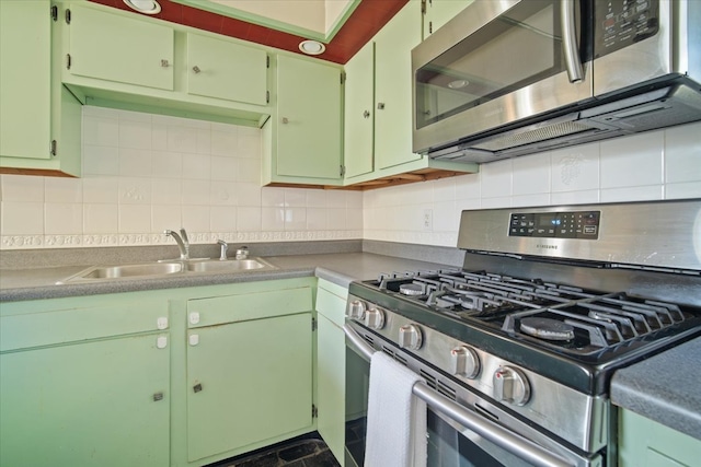 kitchen with decorative backsplash, appliances with stainless steel finishes, and sink