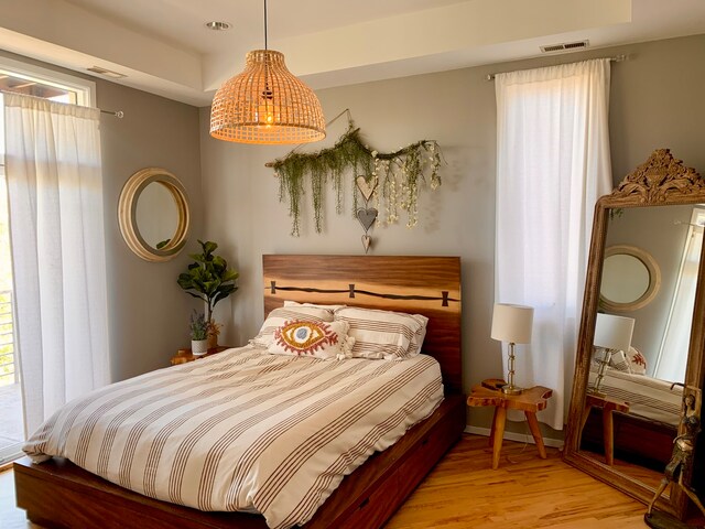 bedroom featuring access to outside and light hardwood / wood-style flooring