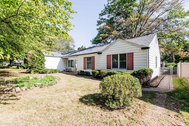 ranch-style home featuring a front yard