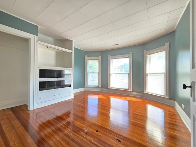 unfurnished living room with hardwood / wood-style flooring and a wealth of natural light