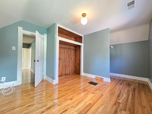 unfurnished bedroom featuring light wood-type flooring and a closet