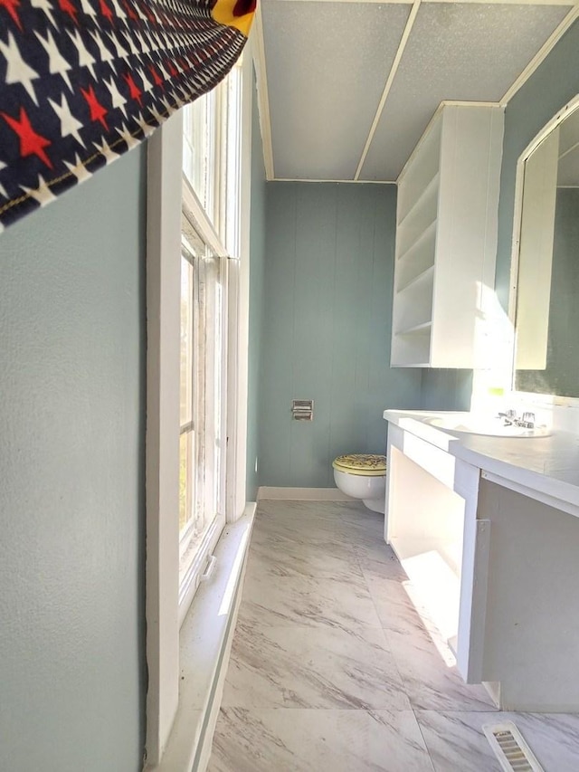 702 Franklin St, Waukegan, IL 60085 - bathroom with toilet, vanity, and baseboards