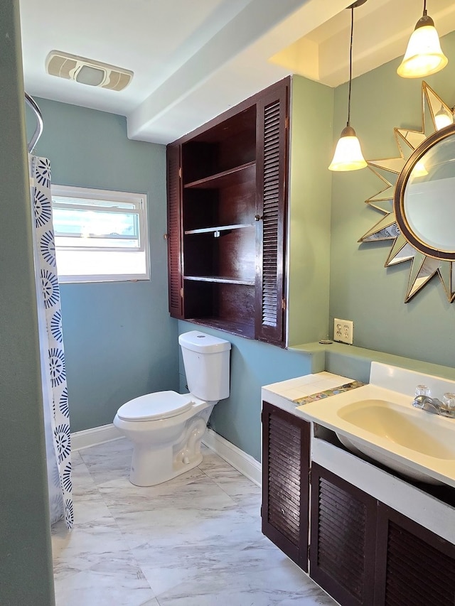 bathroom featuring vanity and toilet