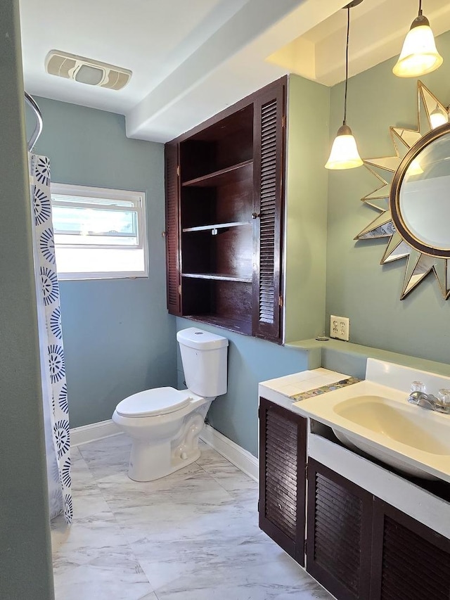 702 Franklin St, Waukegan, IL 60085 - full bathroom featuring toilet, vanity, baseboards, marble finish flooring, and a shower with curtain