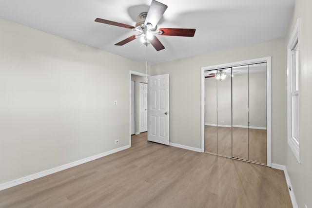 unfurnished bedroom with light wood-type flooring and ceiling fan