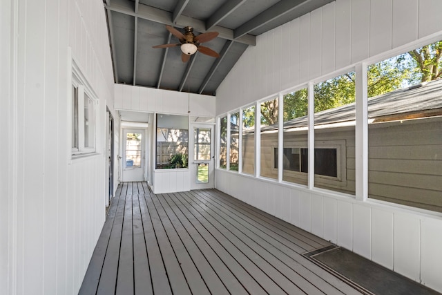 unfurnished sunroom with ceiling fan and vaulted ceiling with beams