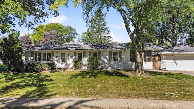 single story home with a front yard and a garage