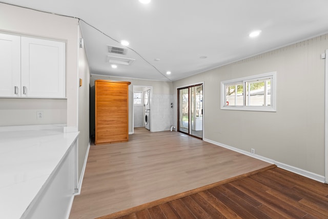 interior space featuring light stone countertops, white cabinets, and light hardwood / wood-style flooring