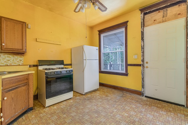 kitchen with ceiling fan, sink, and white appliances