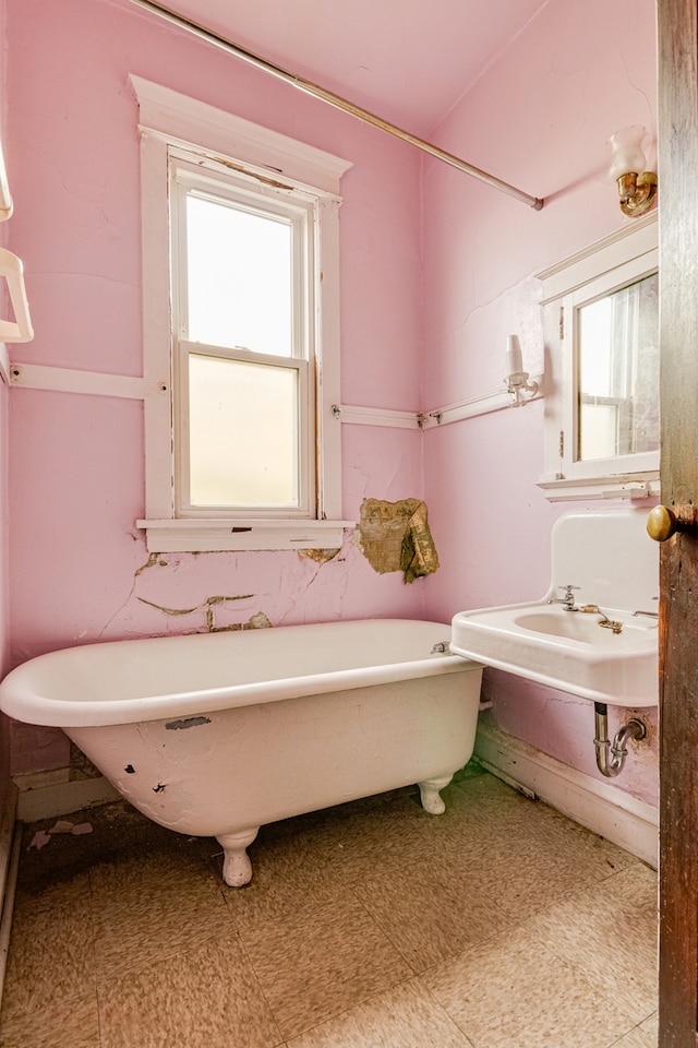 bathroom with plenty of natural light and a bath