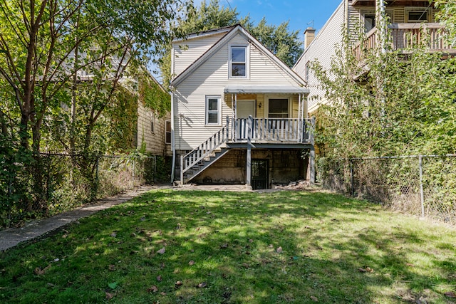 back of house featuring a yard