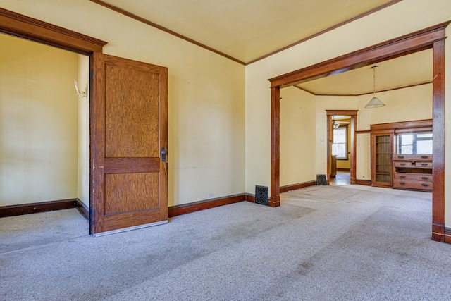 carpeted empty room featuring crown molding