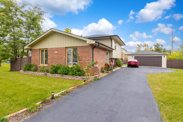 view of front of house featuring a garage and a front lawn