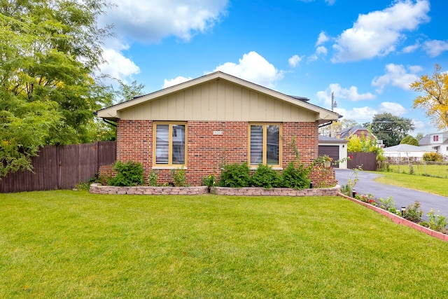 view of side of property with a yard and a garage