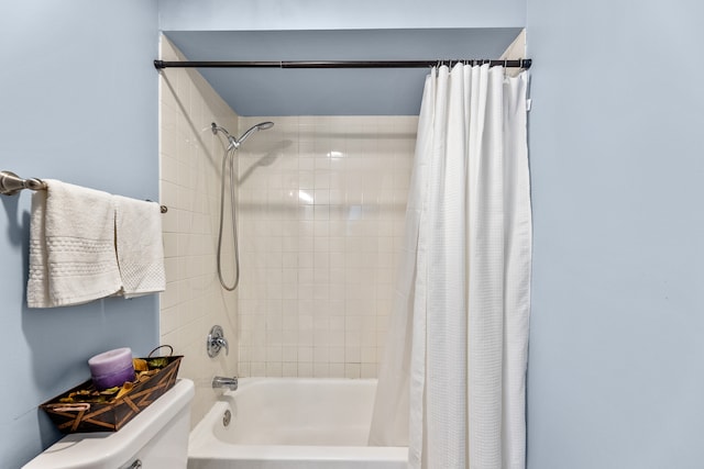 bathroom with shower / bath combo and toilet