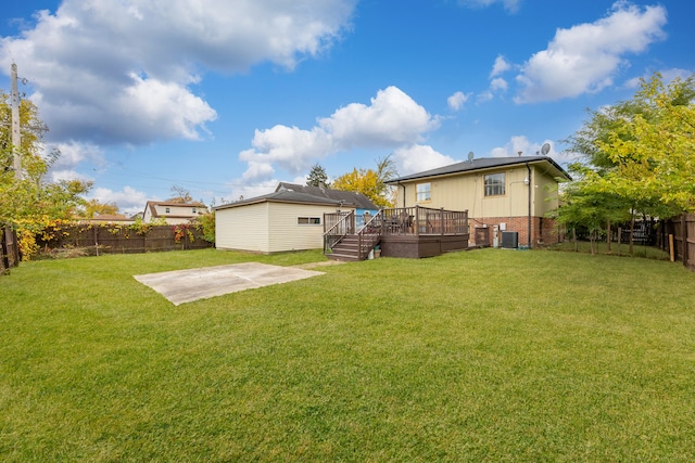 view of yard featuring a deck, a patio area, and central AC unit