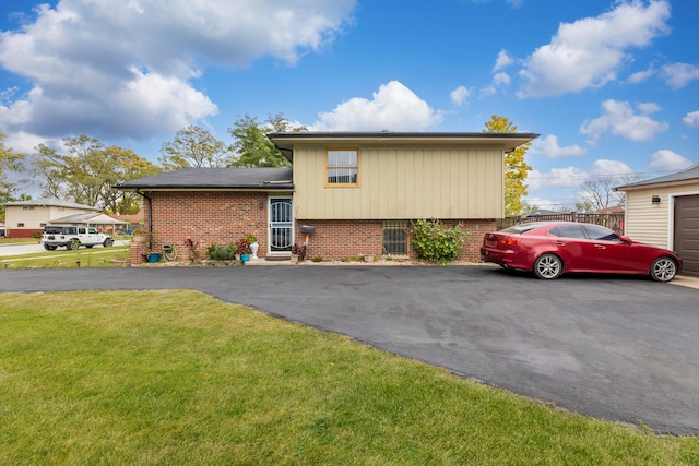 split level home featuring a front lawn