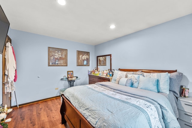 bedroom with dark hardwood / wood-style flooring