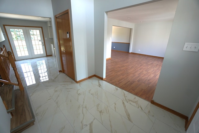 hall featuring french doors and light hardwood / wood-style floors