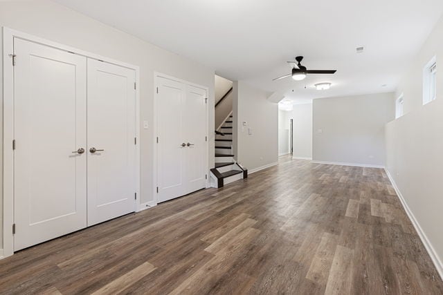 interior space with ceiling fan and dark wood-type flooring