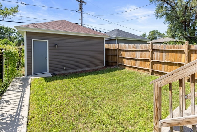 view of yard featuring an outdoor structure and fence