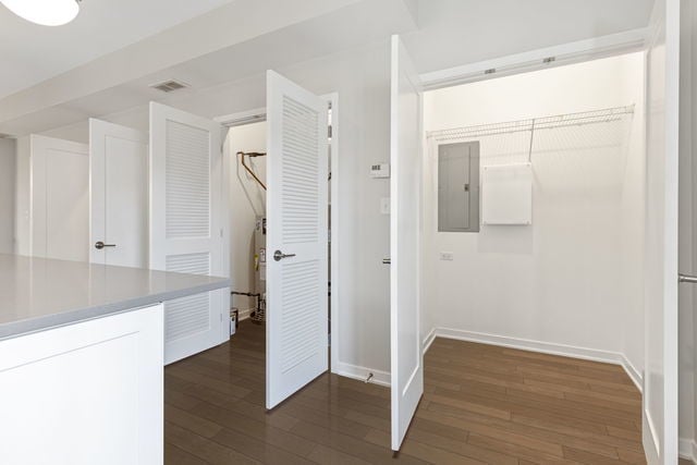 interior space with electric panel and dark hardwood / wood-style floors