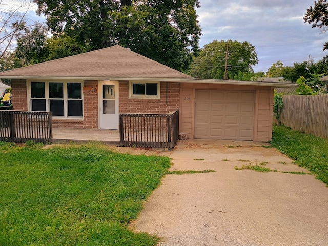 ranch-style house with a garage and a front yard